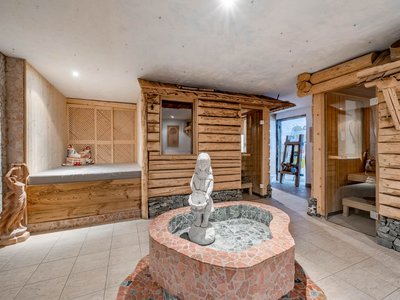 Relax & unwind • Der Grubacher: Eco Hotel in Gerlos Wellness area with fountain, seating niche, and saunas