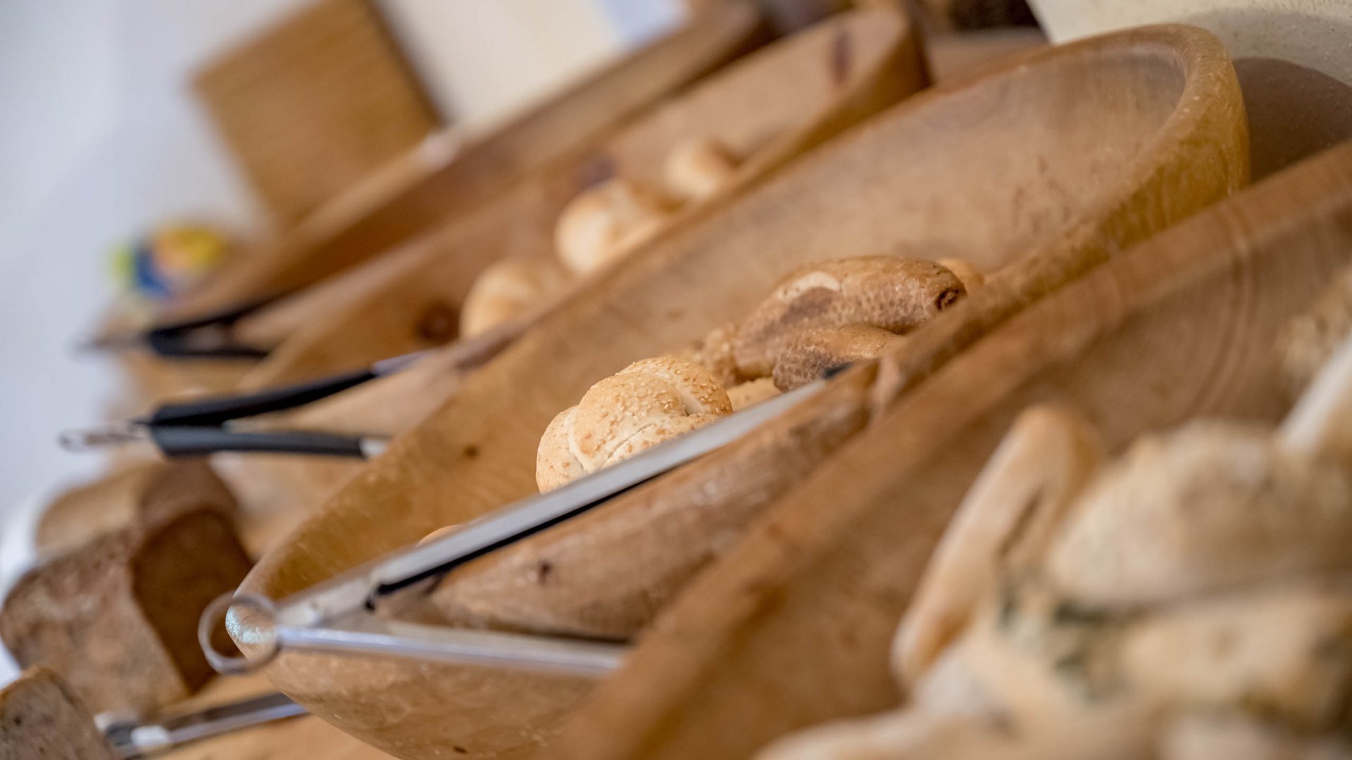 Romantische Dinner in Gerlos • Der Grubacher: Biohotel in Tirol Frisches Brot mit Greifzahnen in Holzschüsseln
